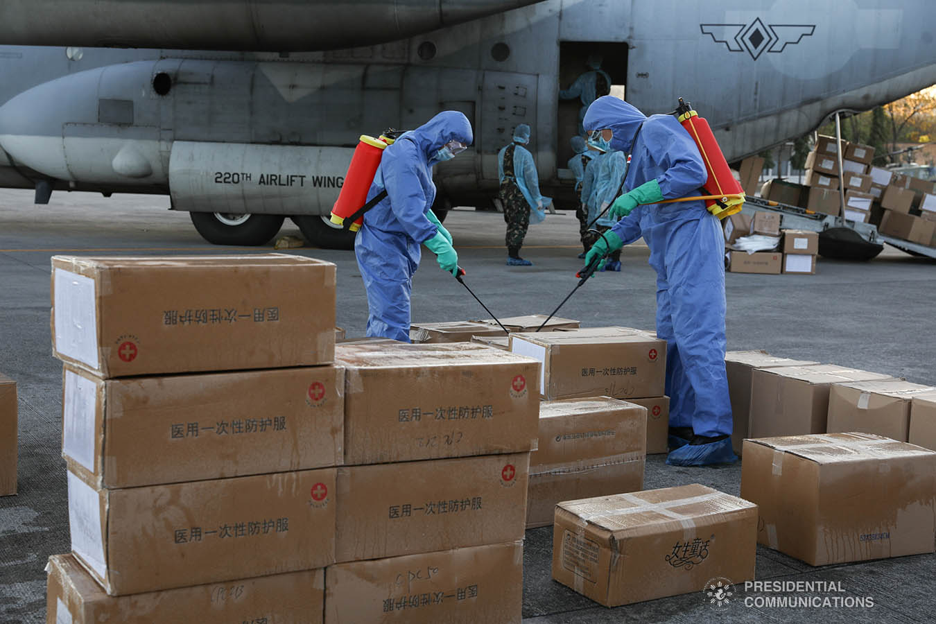 The aid packazges donated by the People's Republic of China undergo disinfection upon arrival at the Villamor Air Base in Pasay City on March 21, 2020. The donation includes assorted medical supplies, personal protective equipment, and testing kits for coronavirus. TOTO LOZANO/PRESIDENTIAL PHOTO