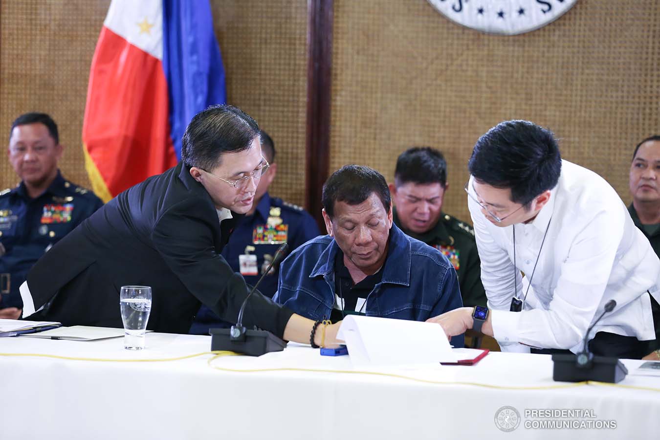 President Rodrigo Roa Duterte confers with Senator Christopher "Bong" Go and Cabinet Secretary Karlo Nograles during the meeting with the Inter-Agency Task Force on the Emerging Infectious Diseases (IATF-EID) at the Malacañan Palace on March 12, 2020. RICHARD MADELO/PRESIDENTIAL PHOTO
