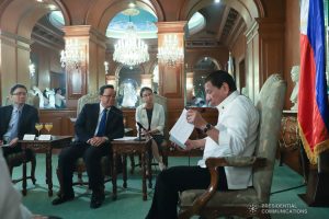 President Rodrigo Roa Duterte reads a document while discussing matters with Ambassador of the People's Republic of China to the Philippines Huang Xilian who paid a courtesy call on the President at the Malacañan Palace on March 11, 2020. REY BANIQUET/PRESIDENTIAL PHOTO