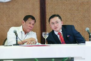 President Rodrigo Roa Duterte chats with Senator Christopher "Bong" Go during a meeting to discuss