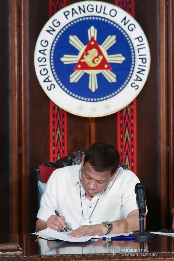 President Rodrigo Roa Duterte reviews a document before addressing the nation on the government's efforts in addressing the coronavirus disease (COVID-19) at the Malago Clubhouse in Malacañang on April 3, 2020. TOTO LOZANO/PRESIDENTIAL PHOTO
