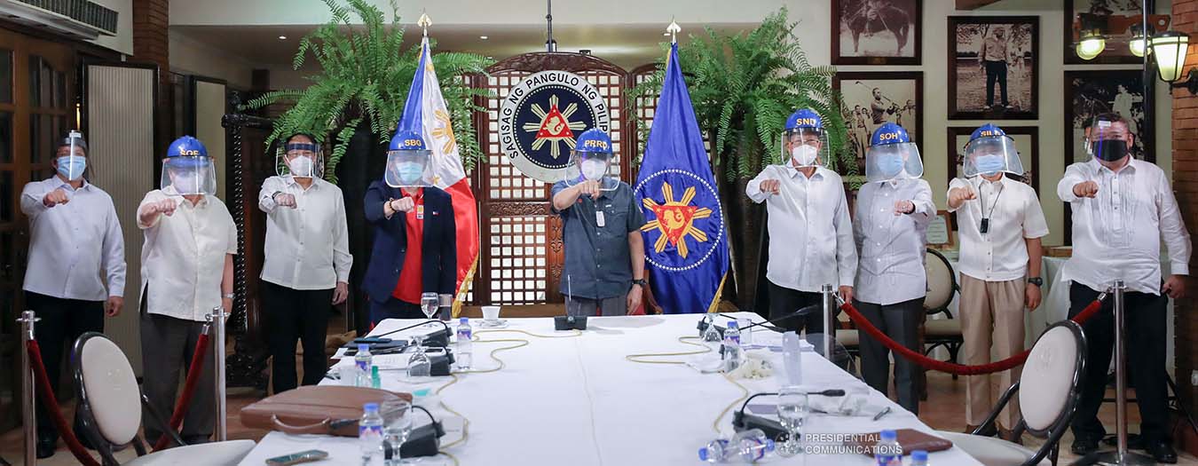 President Rodrigo Roa Duterte strikes his signature pose with members of the Inter-Agency Task Force on the Emerging Infectious Diseases (IATF-EID) following a meeting at the Malago Clubhouse in Malacañang on May 11, 2020. ACE MORANDANTE/PRESIDENTIAL PHOTO