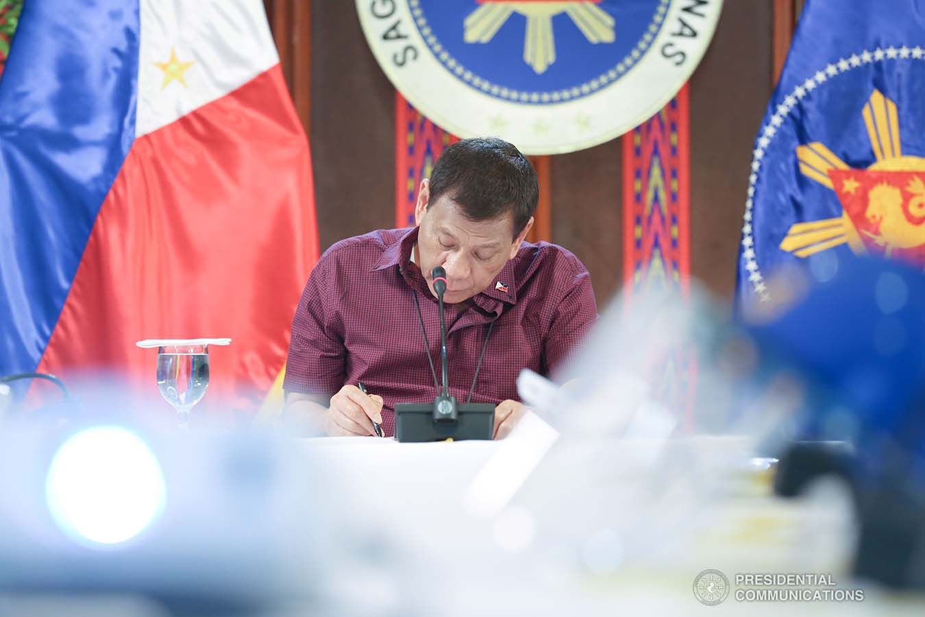President Rodrigo Roa Duterte reviews a document while holding a meeting with members of the Inter-Agency Task Force on the Emerging Infectious Diseases (IATF-EID) at the Malago Clubhouse in Malacañang on May 19, 2020. KARL NORMAN ALONZO/PRESIDENTIAL PHOTO