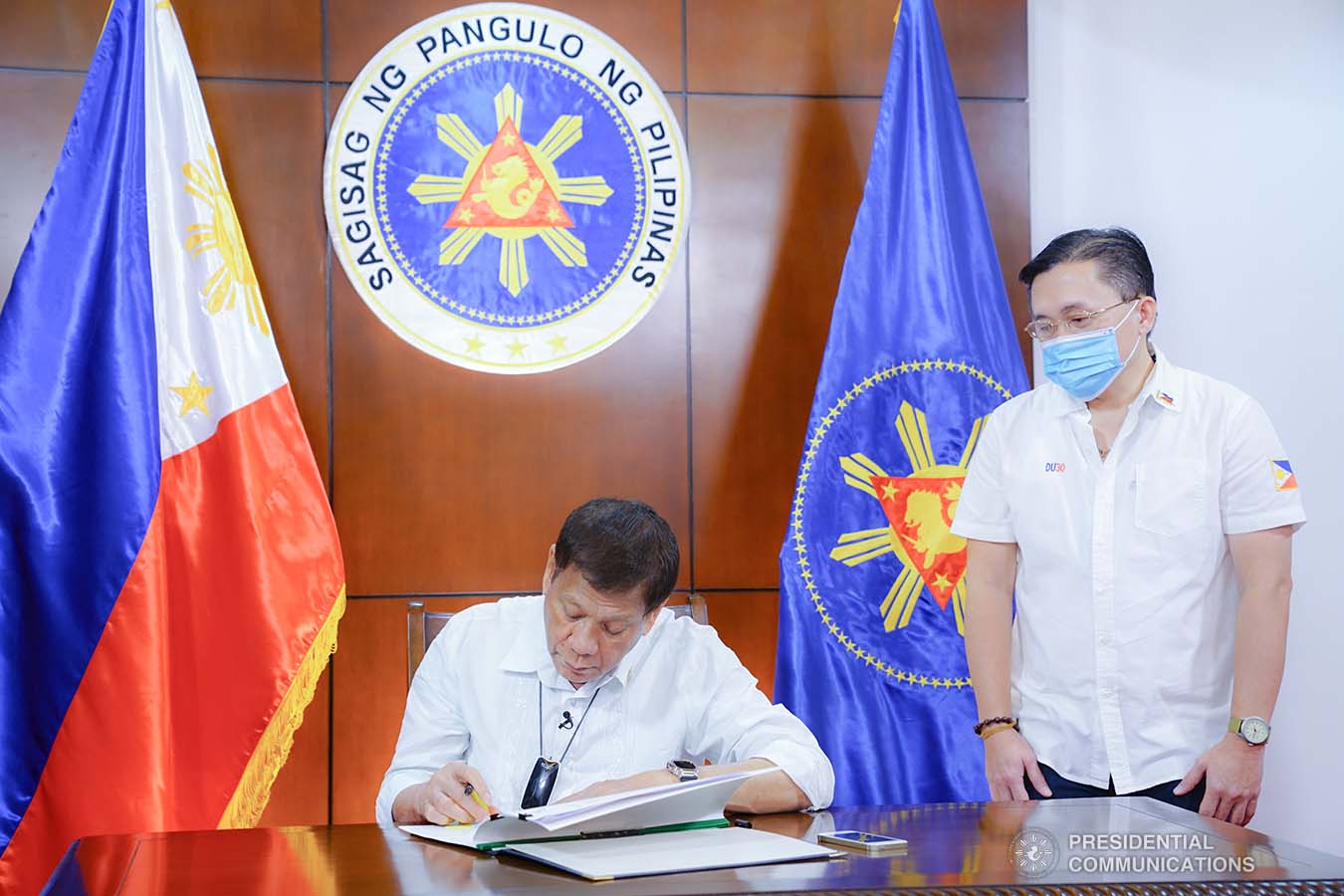 President Rodrigo Roa Duterte signs into law the establishment of the National Academy of Sports during a ceremony at the Presidential Guest House in Panacan, Davao City on June 9, 2020. With the President is Senator Christopher "Bong" Go. JOEY DALUMPINES/PRESIDENTIAL PHOTO