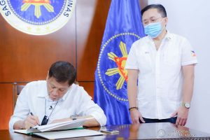 President Rodrigo Roa Duterte signs into law the establishment of the National Academy of Sports during a ceremony at the Presidential Guest House in Panacan, Davao City on June 9, 2020. With the President is Senator Christopher "Bong" Go. JOEY DALUMPINES/PRESIDENTIAL PHOTO