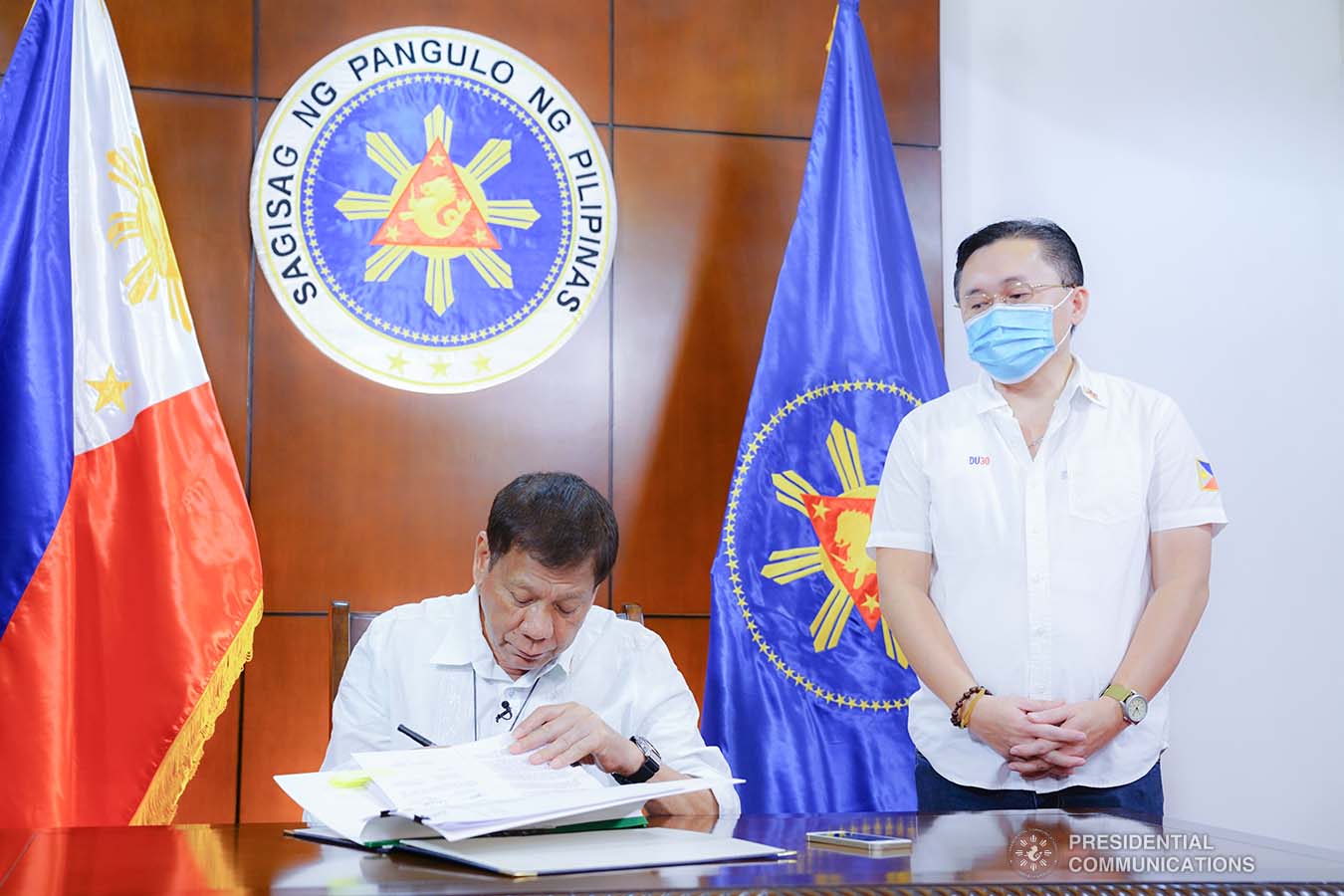 President Rodrigo Roa Duterte signs into law the establishment of the National Academy of Sports during a ceremony at the Presidential Guest House in Panacan, Davao City on June 9, 2020. With the President is Senator Christopher "Bong" Go. JOEY DALUMPINES/PRESIDENTIAL PHOTO