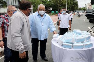Executive Secretary Salvador Medialdea inspects some of the face masks donated by Tasan Health and Medical Tech (Shanghai) Company Limited prior to the start of the ceremonial turnover at the Rizal Park Hotel in Manila on September 17, 2020. REY BANIQUET/ PRESIDENTIAL PHOTOS