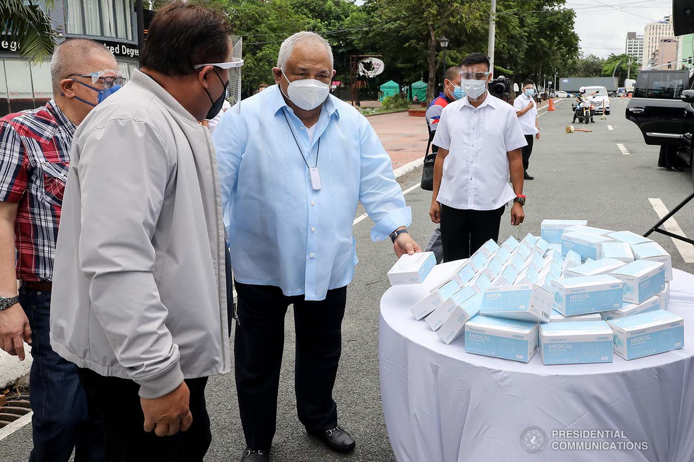 Executive Secretary Salvador Medialdea inspects some of the face masks donated by Tasan Health and Medical Tech (Shanghai) Company Limited prior to the start of the ceremonial turnover at the Rizal Park Hotel in Manila on September 17, 2020. REY BANIQUET/ PRESIDENTIAL PHOTOS