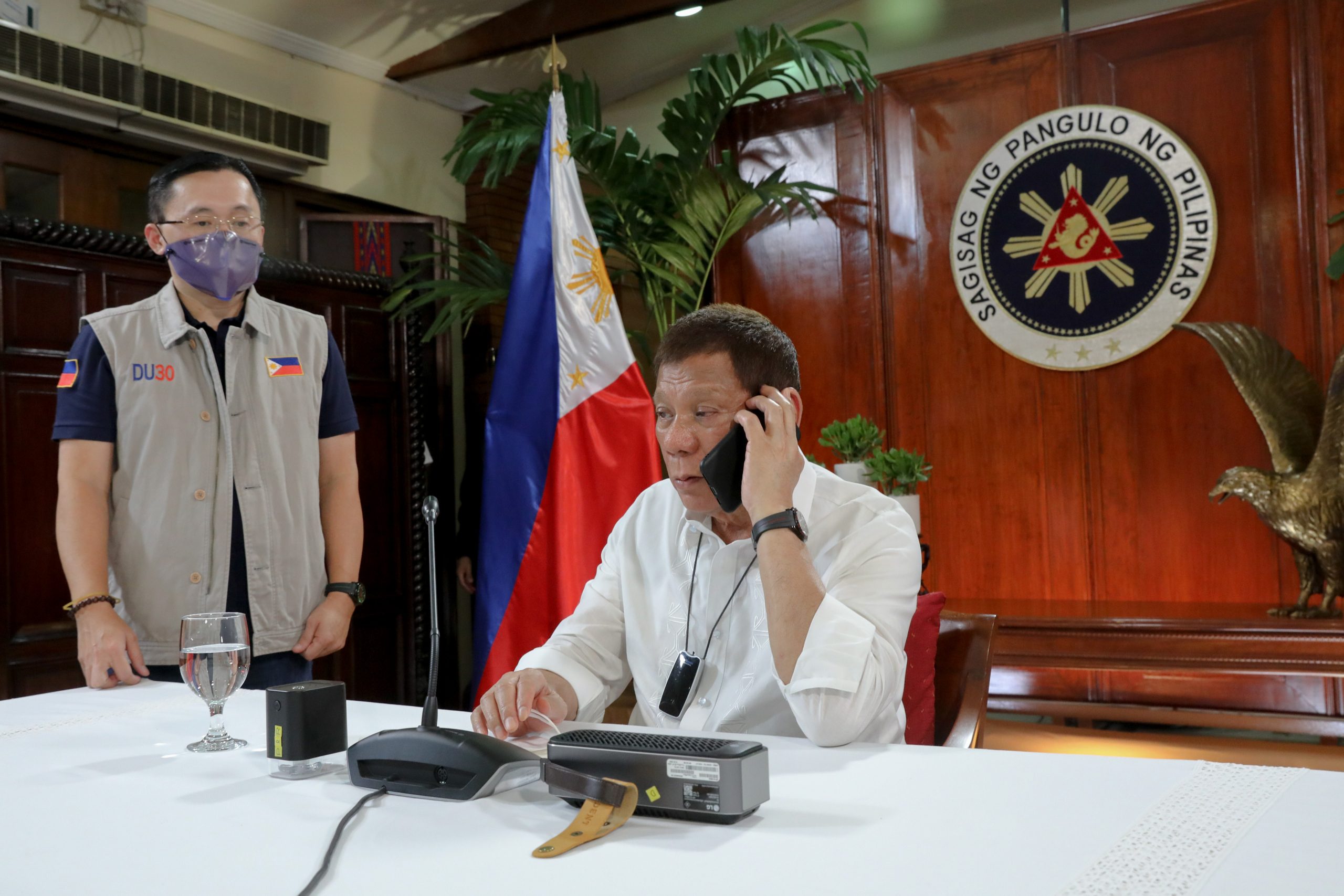 President Rodrigo Roa Duterte talks on the phone with PDEA Director General Wilkins Villanueva following his meeting with the Inter-Agency Task Force on the Emerging Infectious Diseases (IATF-EID) core members  at the Malacañang Golf (Malago) Clubhouse in Malacañang Park, Manila on October 14, 2020. Joining the President is Senator Christopher "Bong" Go. ROBINSON NIÑAL/ PRESIDENTIAL PHOTO