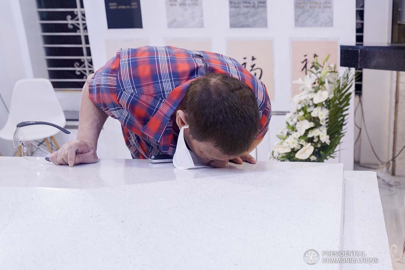 President Rodrigo Roa Duterte kisses the resting place of his parents, Vicente Duterte, the former governor of then undivided Davao Province, and Soledad Duterte, one of Davao’s respected civic leaders, during his visit at the Roman Catholic Cemetery in Davao City on October 28, 2020. The President, as an annual tradition, visits the family mausoleum during All Saints or All Souls Day even when he was still mayor of Davao City. ARMAN BAYLON/ PRESIDENTIAL PHOTO