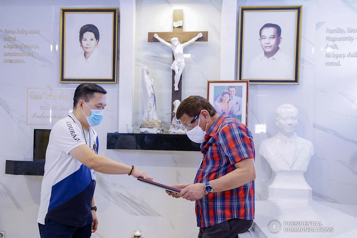 President Rodrigo Roa Duterte is accompanied by Senator Christopher "Bong" Go as he visits the resting place of his parents, Vicente Duterte, the former governor of then undivided Davao Province, and Soledad Duterte, one of Davao’s respected civic leaders, at the Roman Catholic Cemetery in Davao City on October 28, 2020. The President, as an annual tradition, visits the family mausoleum during All Saints or All Souls Day even when he was still mayor of Davao City. JOEY DALUMPINES/PRESIDENTIAL PHOTO