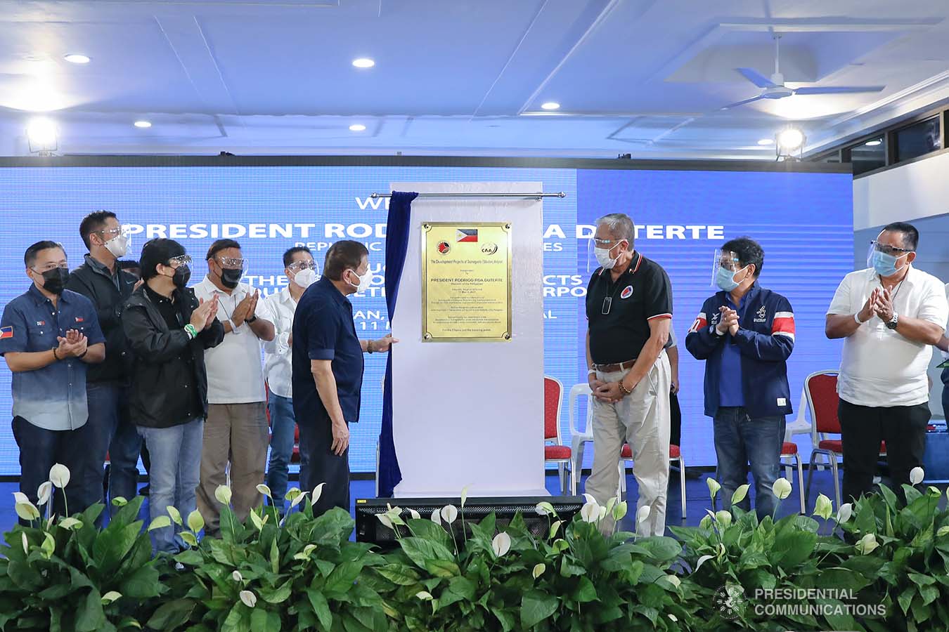 President Rodrigo Roa Duterte leads the unveiling of the marker of the development projects at Dumaguete (Sibulan) Airport in Sibulan, Negros Oriental on March 11, 2021. The President was assisted by Senator Christopher Lawrence “Bong” Go, Transportation Secretary Arthur Tugade, Presidential Assistant for the Visayas Secretary Michael Lloyd Dino, and Civil Aviation Authority of the Philippines Director General Jim Sydiongco. Also present are Presidential Communications and Operations Office Secretary Martin Andanar, Presidential Spokesperson Herminio "Harry" Roque Jr., Chief Presidential Legal Counsel Salvador "Sal" Panelo, Labor and Employment Secretary Silvestre Bello III, and Negros Oriental Governor Roel Degamo. VALERIE ESCALERA/ PRESIDENTIAL PHOTO
