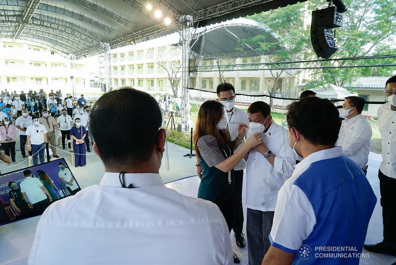 President Rodrigo Roa Duterte is assisted by his partner Honeylet Avanceña while wearing his face mask during the inauguration of newly constructed Gen. Gregorio H. Del Pilar Integrated School and Virginia Ramirez-Cruz High School buildings in Bulakan, Bulacan on March 4, 2021. KING RODRIGUEZ/ PRESIDENTIAL PHOTO