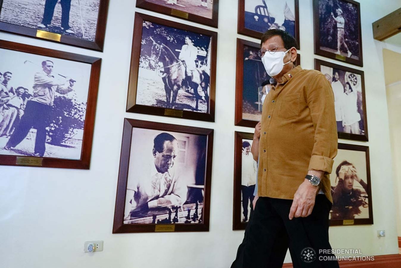 President Rodrigo Roa Duterte walks past old photos of past presidents as he arrives for the meeting with the Inter-Agency Task Force on the Emerging Infectious Diseases (IATF-EID) core members at the Malacañang Golf (Malago) Clubhouse in Malacañang Park, Manila on April 15, 2021. KING RODRIGUEZ/ PRESIDENTIAL PHOTO