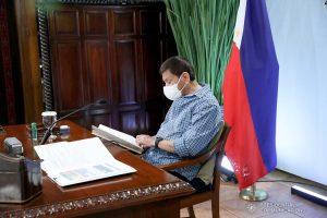 President Rodrigo Roa Duterte skims through a document as he presides over a meeting with the Inter-Agency Task Force on the Emerging Infectious Diseases (IATF-EID) core members prior to his talk to the people at the Malacañang Golf (Malago) Clubhouse in Malacañang Park, Manila on May 13, 2021. ROBINSON NIÑAL/ PRESIDENTIAL PHOTO