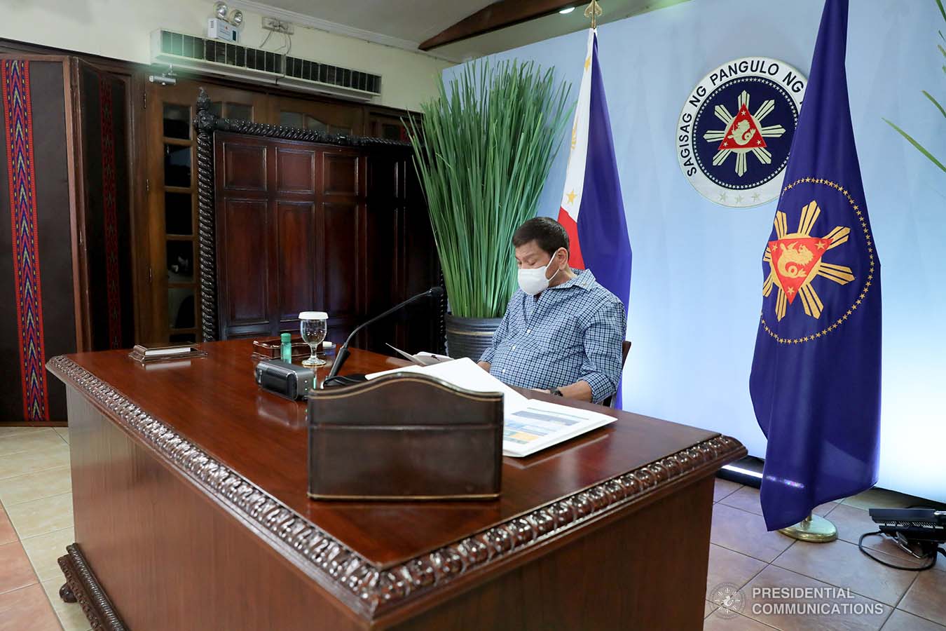 President Rodrigo Roa Duterte skims through a document as he presides over a meeting with the Inter-Agency Task Force on the Emerging Infectious Diseases (IATF-EID) core members prior to his talk to the people at the Malacañang Golf (Malago) Clubhouse in Malacañang Park, Manila on May 13, 2021. ROBINSON NIÑAL/ PRESIDENTIAL PHOTO