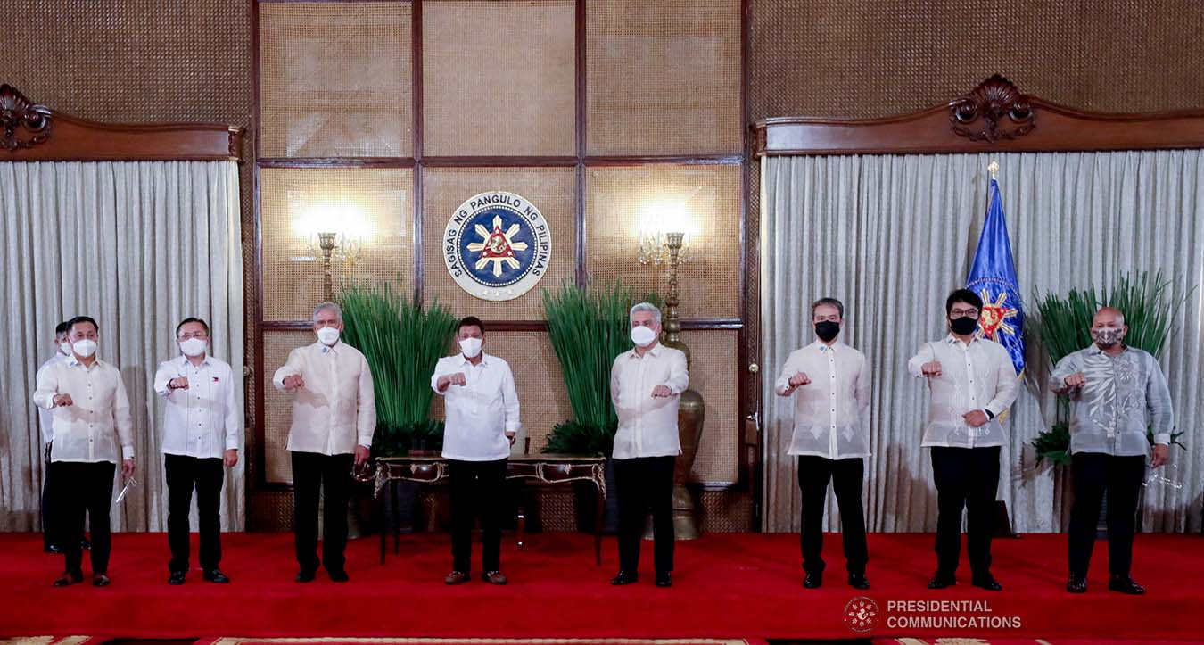 President Rodrigo Roa Duterte strikes his signature pose with (left to right) Senators Francis Tolentino, Christopher Lawrence Go, Vicente Sotto III, Juan Miguel Zubiri, Joel Villanueva, Bong Revilla, and Ronald Dela Rosa following the ceremonial re-enactment of the signing of bills at the Malacañang Palace on June 16, 2021. TOTO LOZANO/ PRESIDENTIAL PHOTO