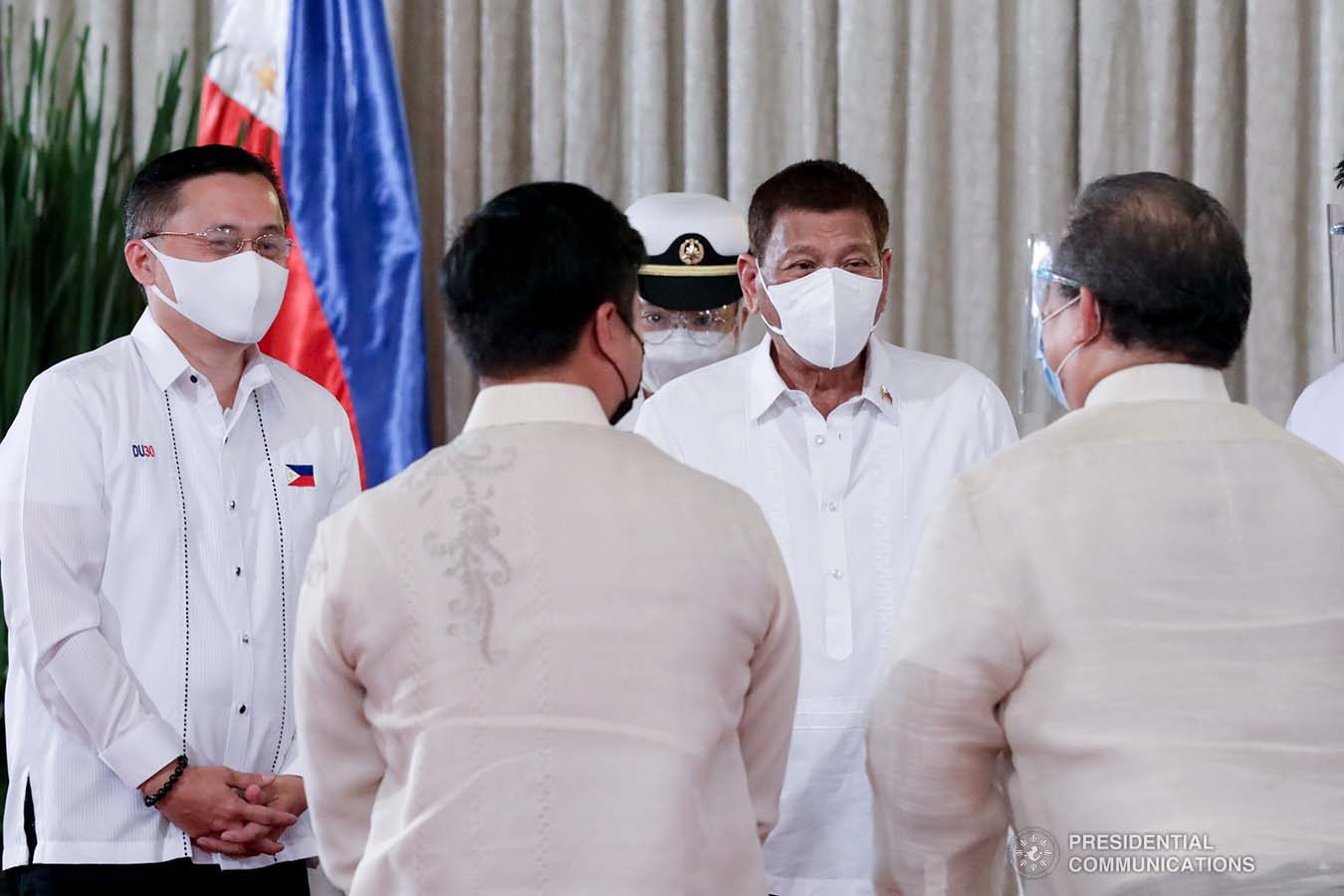 President Rodrigo Roa Duterte discusses matters with  legislators and officials from various agencies on the sidelines following the ceremonial re-enactment of the signing of bills at the Malacañang Palace on June 16, 2021. TOTO LOZANO/ PRESIDENTIAL PHOTO
