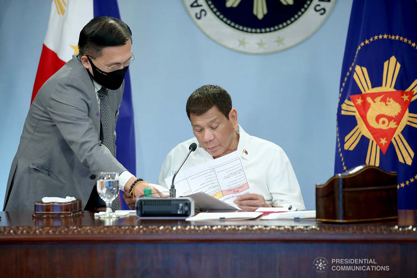 President Rodrigo Roa Duterte is assisted by Senator Christopher Lawrence Go while presiding over a meeting with the Inter-Agency Task Force on the Emerging Infectious Diseases (IATF-EID) core members at the Malacanang Golf (Malago) Clubhouse in Malacanang Park, Manila on May 31, 2021. ROBINSON NIÑAL/ PRESIDENTIAL PHOTO