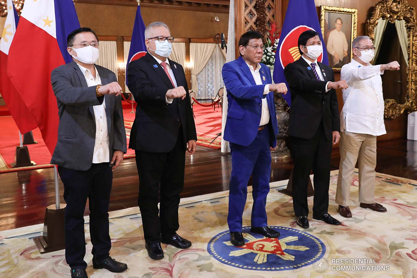 President Rodrigo Roa Duterte flashes his signature pose with Senator Christopher Lawrence Go, Trade and Industry Secretary Ramon Lopez, Social Welfare and Development Secretary Rolando Joselito Bautista and Foreign Affairs Secretary Teodoro Locsin Jr. following the virtual plenary session of the 38th and 39th Association of Southeast Asian Nations (ASEAN) Summits and Related Summits at the Malacañang Palace on October 28, 2021. ALBERTO ALCAIN/ PRESIDENTIAL PHOTO