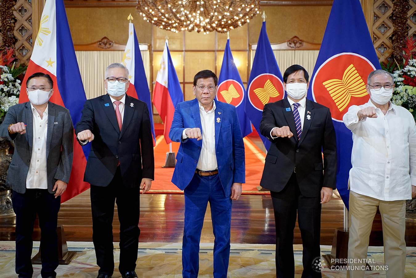 President Rodrigo Roa Duterte flashes his signature pose with Senator Christopher Lawrence Go, Trade and Industry Secretary Ramon Lopez, Social Welfare and Development Secretary Rolando Joselito Bautista and Foreign Affairs Secretary Teodoro Locsin Jr. following the virtual plenary session of the 38th and 39th Association of Southeast Asian Nations (ASEAN) Summits and Related Summits at the Malacañang Palace on October 28, 2021. KING RODRIGUEZ/ PRESIDENTIAL PHOTO