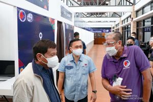 President Rodrigo Roa Duterte shares a light moment with Senator Christopher Lawrence "Bong" Go and Transportation Secretary Arthur Tugade while inspecting the newly constructed Malasakit Hall at the Zamboanga International Airport in Zamboanga City on December 2, 2021. TOTO LOZANO/ PRESIDENTIAL PHOTO